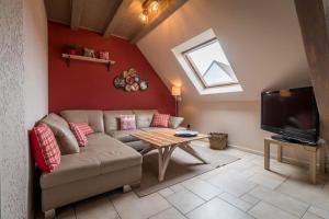 a living room with a couch and a table at Logement 1 à 6 personnes---Le Kelsch in Marlenheim