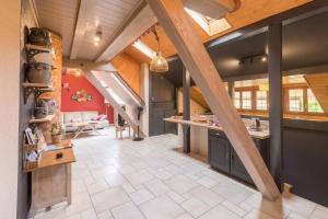 a large kitchen with a vaulted ceiling with wooden beams at Logement 1 à 6 personnes---Le Kelsch in Marlenheim