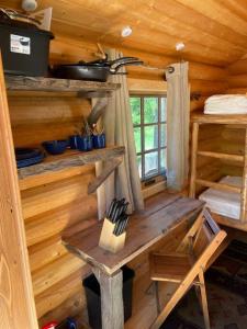 a wooden room with a wooden table in a cabin at Little cabin in the woods in Whitefish