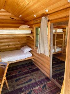 a log cabin with two bunk beds in it at Little cabin in the woods in Whitefish