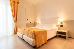 a hotel room with a bed and a window at Continental B&B City Hotel in Bibione