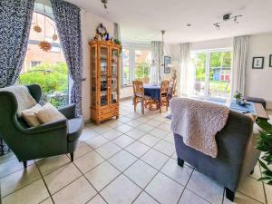 a living room with two chairs and a table at Maubach in Greetsiel