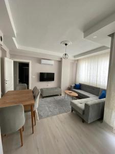 a living room with a couch and a table at 2+1 MUHTEŞEM TATİL EVİ in Dalaman
