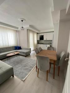 a living room with a table and a couch at 2+1 MUHTEŞEM TATİL EVİ in Dalaman