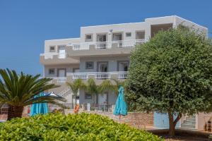 a large white building with trees and umbrellas at Amara Seaside by Estia in Malia