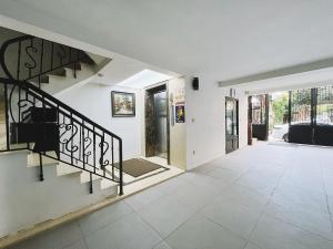 an empty hallway with a staircase in a house at Hanoi Home 8 - Luxury Apartment, open view in Hanoi