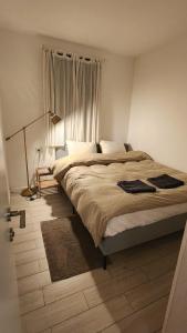 a bedroom with a large bed and a window at Modern Home In The Heart of Nachlaot in Jerusalem