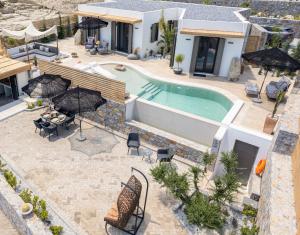 an aerial view of a villa with a swimming pool at Mnḗmē Suites & Villas in Kastrí