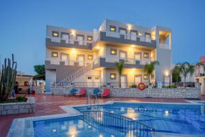 a hotel with a swimming pool in front of a building at Amara Seaside by Estia in Malia