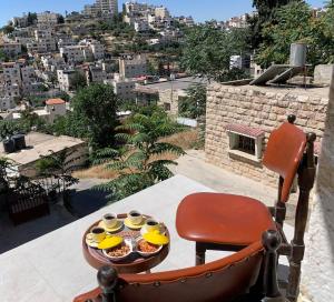 a tray of food on a table on a balcony at Dar Ateeq's Arches/ Bethlehem Apartment in Bethlehem