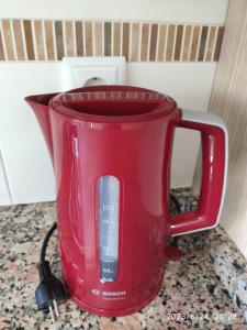 a red coffee pot sitting on a counter at Playa Serena Zen in Roquetas de Mar