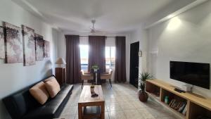 A television and/or entertainment centre at TREBOL Apartamentos Benalmádena