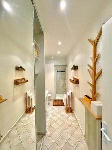 a bathroom with a glass shower stall and a sink at Same Home in Cassis