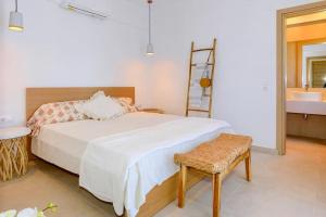 a bedroom with a bed and a chair and a sink at Dilean luxury villa in Vourvourou +34 photos