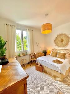 a bedroom with a large bed and a large window at Same Home in Cassis