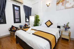 um quarto com duas camas com um cisne na cama em Casablanca Hotel em Hue