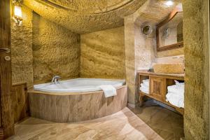a bathroom with a tub in the middle of a room at Utopia Cave Cappadocia in Urgup