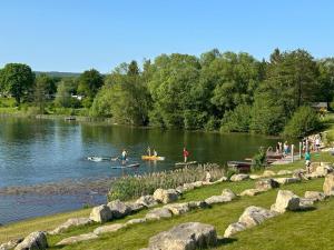 a group of people in the water at a park at Romantisches Tiny House direkt am See, Ruhe & Natur in Salzhemmendorf +16 photos