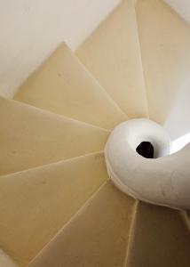 a spiral staircase in a ceiling with a hole at Dar Garigor in Cospicua
