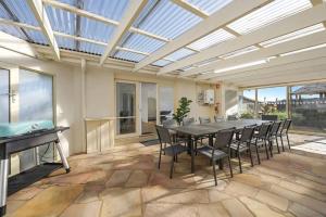 a dining room with a table and chairs at Logans Beach Apartments - BeachHouse in Warrnambool