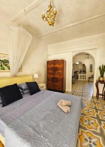 a bedroom with a bed with a towel on it at Dar Garigor in Cospicua