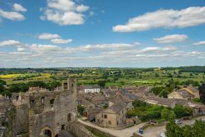 an aerial view of a town with a castle at Corner Cottage in Leyburn