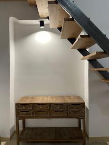 a wooden chest of drawers under a staircase at Casa Noal in Nardò