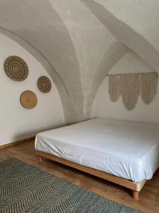 a white bed in a room with a ceiling at Casa Noal in Nardò