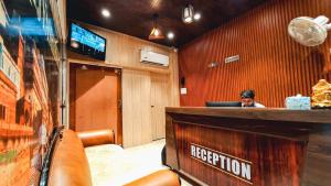 a woman sitting at a reception desk in a restaurant at Hotel Rajyashree Palace in Varanasi