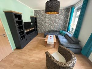 a living room with a couch and a table at Quartier am Nationalparkhaus in Bad Schandau