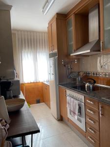 Apartamento en el centro de Miami Platja 155B - INMO22 في هوسبيتاليت دي لانفنت: مطبخ مع حوض وموقد الفرن العلوي