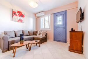 a living room with a couch and a blue door at Seaside & Modern Flats near Chora in Steniaí
