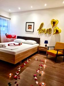 a bedroom with a bed with roses on the floor at Garden Apartments in Ulcinj