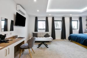 a bedroom with a bed and a desk with a chair at The Wylies in Dunmurry