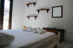 a bedroom with a bed with towels on it at Volcano View Nisyros in Mandrákion
