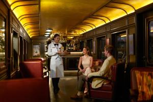 a woman standing in a train with two people at InterContinental Khao Yai Resort, an IHG Hotel in Mu Si
