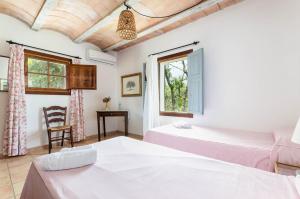 a bedroom with two beds and a window at Finca Es Galliner in Felanitx +47 photos