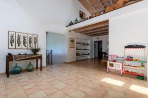 a living room with a table and a room with a floor at Finca Es Galliner in Felanitx