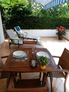 a wooden table and chairs on a patio at House Anita in Krk