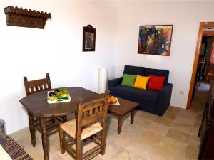a living room with a table and a couch at Eveleos Country House in Tochni