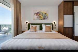 a bedroom with a large white bed with a green headboard at Villa Kate ZadarVillas in Knežević +48 photos