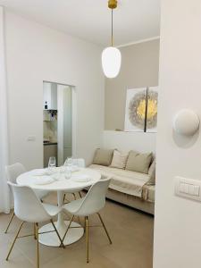 a white living room with a white table and chairs at URBAN SUITE in Bari