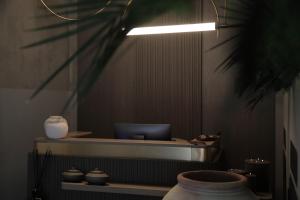 a room with a desk with a laptop and vases at The Sanctuary Urban Retreat in Rome +138 photos