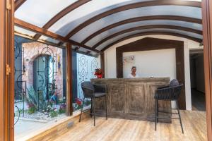a man standing behind a bar in a room with a mirror at Panoramic Konaklama Tesisi Bodrum in Bodrum City