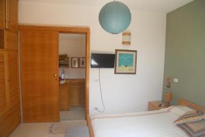 a bedroom with a bed and a blue lamp at Cefalù ORIETTA in Cefalù
