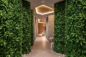 a hallway with a green wall in a building at NissiBlu Beach Resort in Ayia Napa