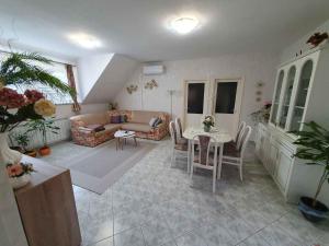 a living room with a couch and a table at Apartment Gyenesdias 18 in Gyenesdiás