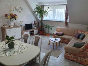 a living room with a table and a couch at Apartment Gyenesdias 18 in Gyenesdiás