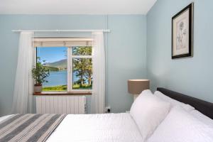 a bedroom with a bed and a window at Cottage 446 - Letterfrack in Letterfrack