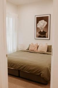 a bedroom with a bed with a picture on the wall at SYLO Luxury Apartments - LVL 2 in Adelaide